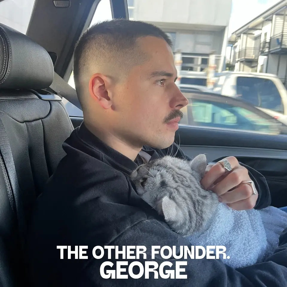 Louis Pet Co co-founder George holding his cat Louis while sitting in a car.